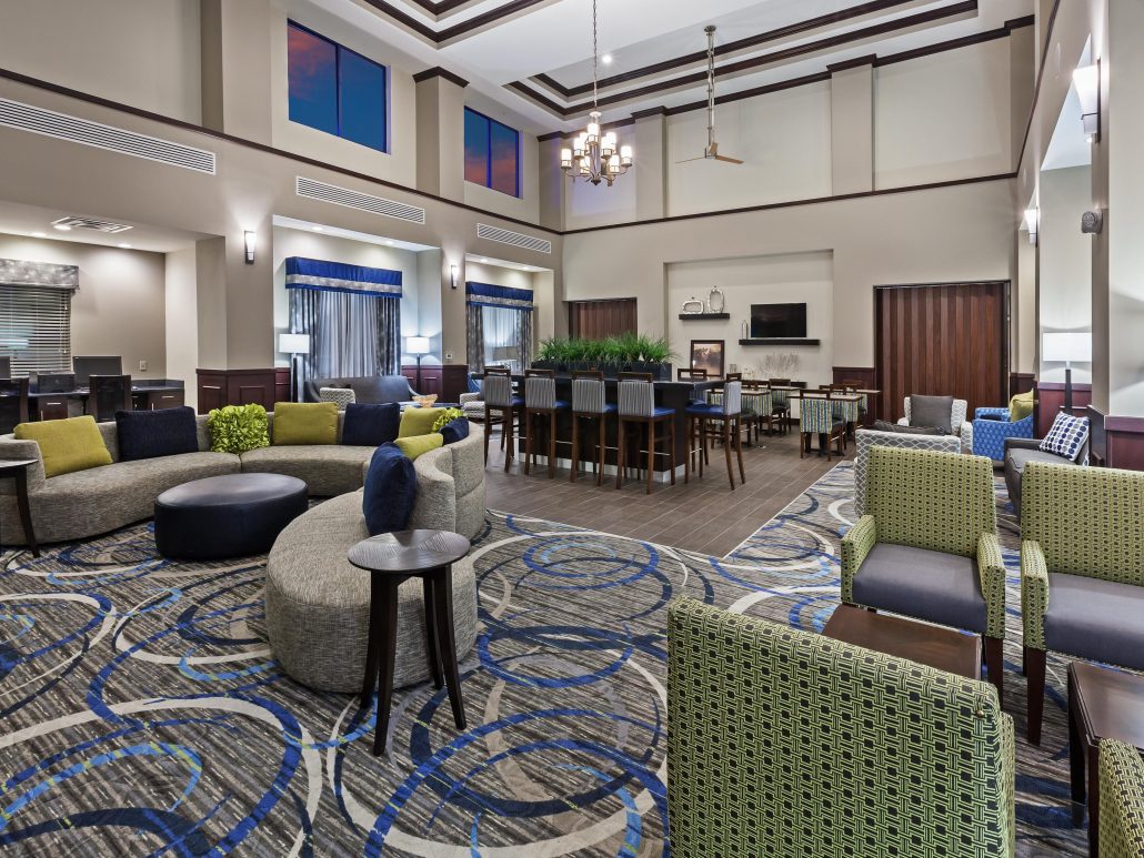 Holiday Inn Express lounge area with sofa, seating and high top table