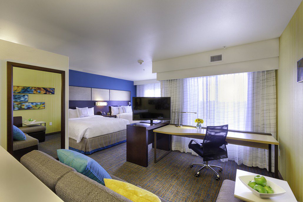 Residence Inn by Marriott room with two queen size beds, a small sofa, and desk