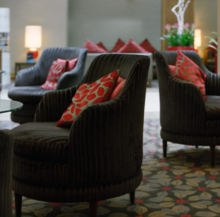 black accent chairs with red throw pillows