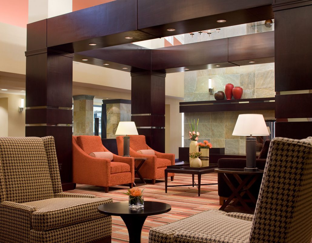 Sheraton Hotel & Conference Center secondary lounge area with seating and tables