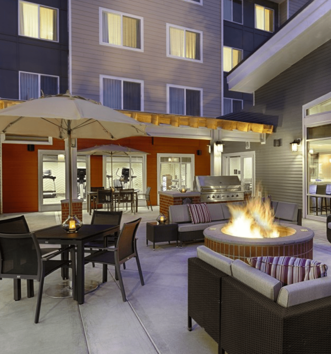 hotel exterior patio with furniture and fireplace