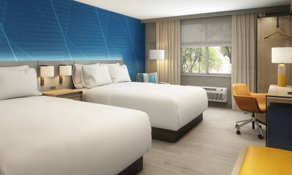 Hotel room with two queen size beds and a blue accent wall