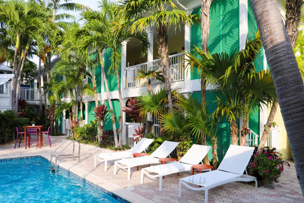 Almond Tree Inn outdoor pool, with beach chairs and palm trees