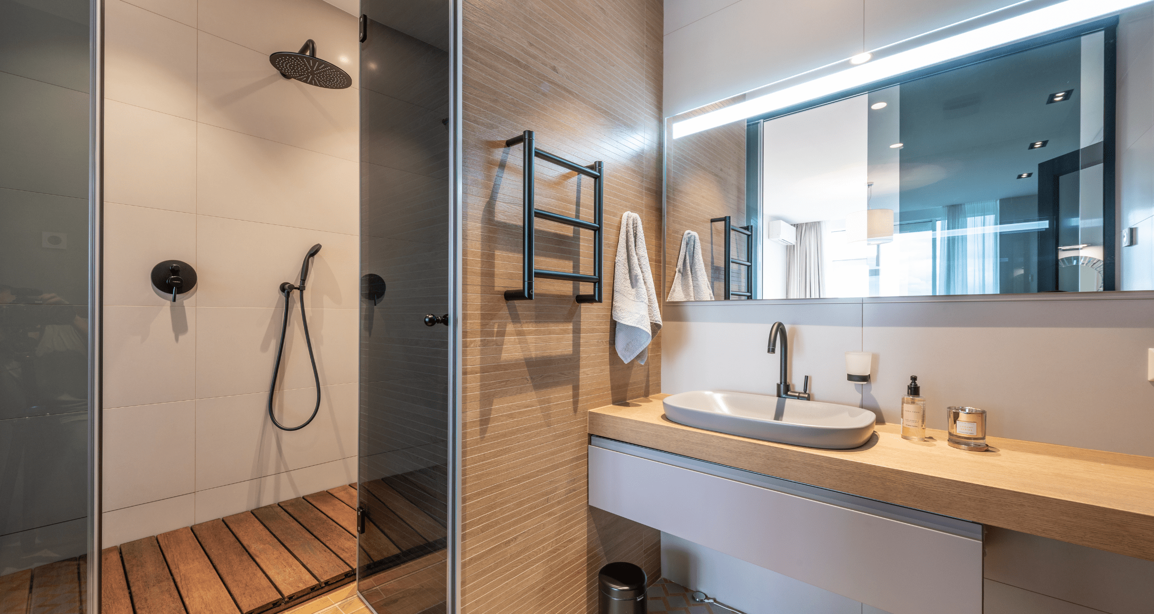 Modern bathroom with wood countertops and walls, with a spacious walk-in shower.
